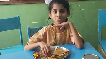 Child eating food at CSED